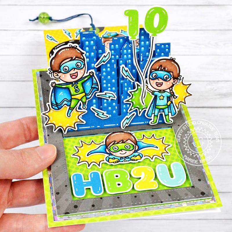 Sunny Studio Superhero with City Buildings Interactive Sliding Pop-up Birthday Card using Balloon Numbers Clear Craft Stamps