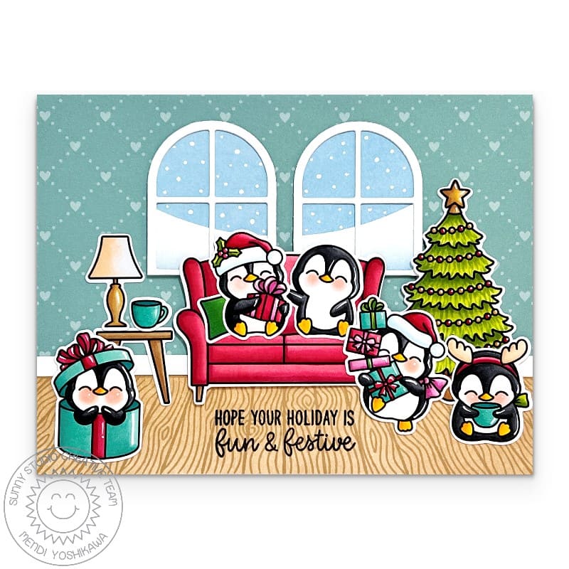 Sunny Studio handmade Christmas card with penguins on a couch & holiday tree, featuring a snowy window background.