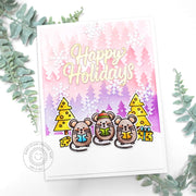 A handmade holiday card featuring mice wearing winter hats & holding gifts, with pink & purple forest with white snowflakes.