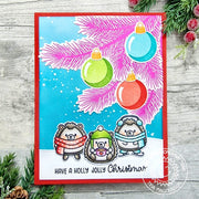 Handmade card featuring a pink holiday tree, colorful ornaments & hedgehogs with the greeting 'HAVE A HOLLY JOLLY Christmas.'
