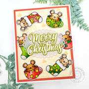 A handmade Christmas card featuring mice sitting in colorful Christmas stockings & teacups, with 'Merry Christmas' greeting.