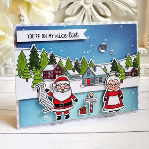Sunny Studio Santa & Mrs. Claus at North Pole with Houses & Fir Trees Holiday Christmas Card using Winter Scenes Clear Stamp