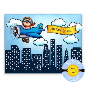 Sunny Studio Stamps Plane Awesome Sending Hugs blue airplane flying over city with clouds and yellow banner handmade Card