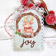 A pale blue scalloped Christmas "Joy" tag featuring a no-line coloring reindeer leaping through a holiday grapevine wreath.